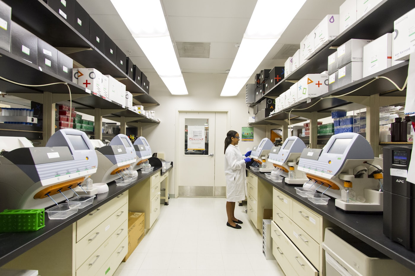 Analytical laboratory with a technician operating a row of instruments